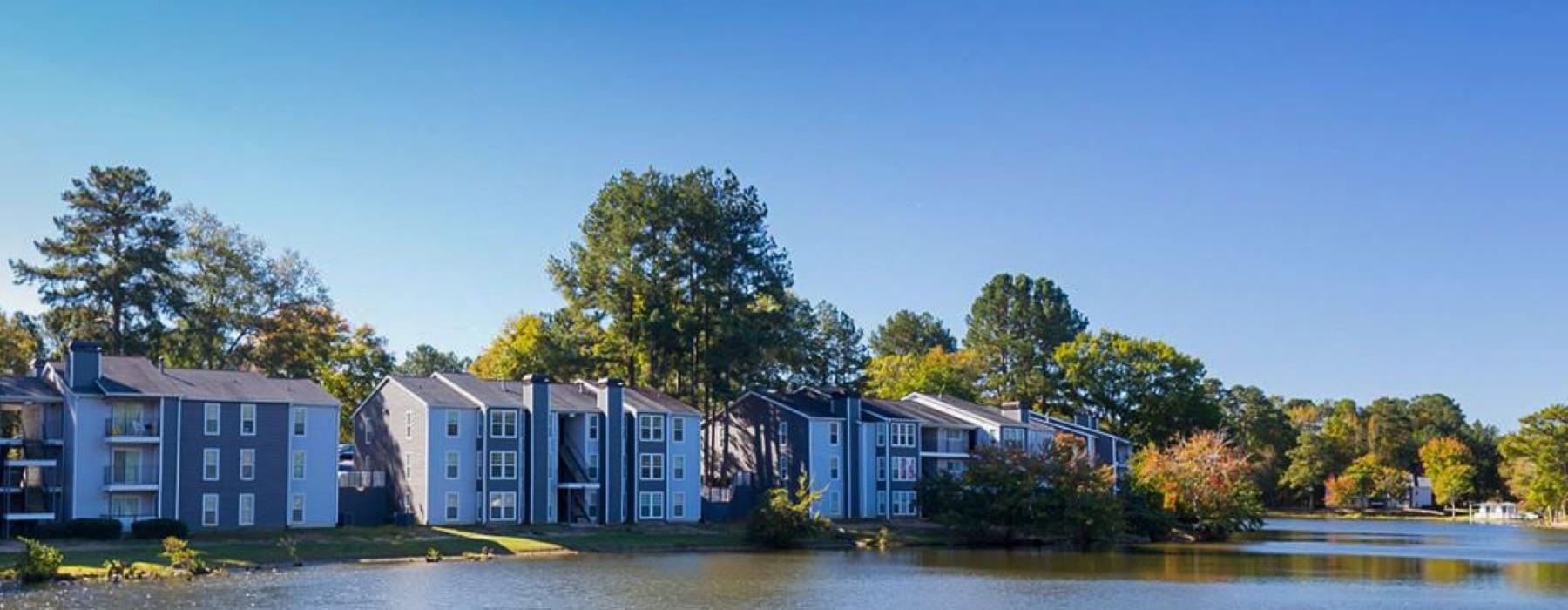 a row of apartments next to a body of water